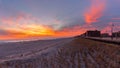 Vibrant colorful sunset over the Long Beach boardwalk and seaside. Panorama