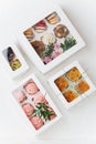 Vibrant colorful sweets in white windowed boxes. Top view