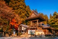 Vibrant colourful maple tree and Shoro bell tower Yamadera Temple in autumn - Yamagata, Japan