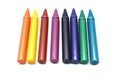Vibrant crayons in various colors are aligned in a row with a clean, simple backdrop highlighting their brightness and texture Royalty Free Stock Photo