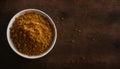 Vibrant Curry Powder in a White Bowl on Rustic Wooden Table, Copy Space Royalty Free Stock Photo