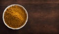 Vibrant Curry Powder in a White Bowl on Rustic Wooden Table, Copy Space Royalty Free Stock Photo