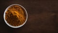 Vibrant Curry Powder in a White Bowl on Rustic Wooden Table, Copy Space Royalty Free Stock Photo