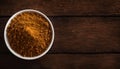 Vibrant Curry Powder in a White Bowl on Rustic Wooden Table, Copy Space Royalty Free Stock Photo