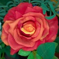 Vibrant dark orange fake rose top view closeup Royalty Free Stock Photo