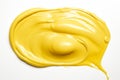 Vibrant and delicious single splash of yellow mustard sauce isolated on white background