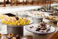 A vibrant dessert buffet features assorted sweets, including cakes and pastries, beautifully arranged on silver platters ready for Royalty Free Stock Photo
