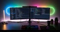 Vibrant Developer Workspace with Dual Monitors and Neon Glow Royalty Free Stock Photo