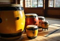 Colorful conga drums arranged in a bright, sunlit room Royalty Free Stock Photo