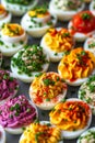 A vibrant display of deviled eggs featuring a variety of toppings and fillings