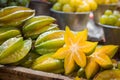 A vibrant display of fresh, juicy starfruits at a market, highlighting natural and healthy choices. Royalty Free Stock Photo