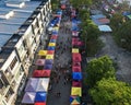 Vibrant display of market tents set up on a city street in front of towering urban skyscrapers Royalty Free Stock Photo