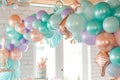 A vibrant display of various colored balloons hanging from the ceiling in a cheerful setting, Mermaid color balloon garland for an Royalty Free Stock Photo