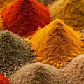 A vibrant display of various spices forming small mounds. The image prominently features bright Royalty Free Stock Photo