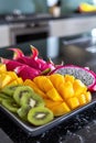 Vibrant exotic fruit platter with dragon fruit and kiwi, AI Generated.