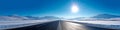 Vibrant extra wide panoramic sky. Winter highway. Snow covered street leading to the horizon