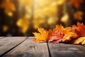 Vibrant fall leaves rest on a rustic wooden table, autumn themed Royalty Free Stock Photo