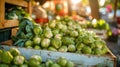 A vibrant farmers market stall, brimming with fresh Brussels sprouts on the stalk, along with other green vegetables