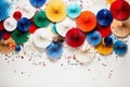 Vibrant Festive Decorations: Colorful Paper Fans, Balloons, and Confetti on White Background