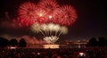 Vibrant fireworks explode over water, watched by a massive crowd Royalty Free Stock Photo