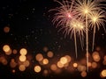 Vibrant Fireworks Exploding in Night Sky with Golden Bokeh Lights for Celebration Background Royalty Free Stock Photo