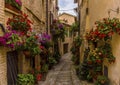 Vibrant flowers adorn a narrow alleyway in the hilltop village of Spello, Umbria Royalty Free Stock Photo