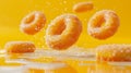 Vibrant Flying Sugar Coated Doughnuts on Bright Yellow Background with Dynamic Splashes and Reflections