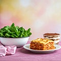 Vibrant food setup with lasagna, spinach, and dessert Royalty Free Stock Photo