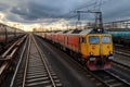 Vibrant freight trains on railway station, goods transported on colorful wagons