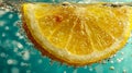 Vibrant fresh lemon slice submerged in sparkling water with effervescent bubbles creating a refreshing and invigorating citrus Royalty Free Stock Photo