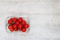 Vibrant freshness: Tomatoes in a glass bowl on white textured background with copy space