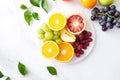 Vibrant fruit platter with berries, apples, and citrus slices on marble surface Royalty Free Stock Photo
