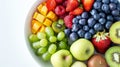 Vibrant fruit platter on white surface perfect for nutrition ads with ample text space