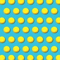 Vibrant geometric pattern of yellow macaroons on turquoise background