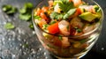 A vibrant glass of shrimp ceviche with fresh tomato, avocado, and cilantro, capturing the essence of Mexican seafood Royalty Free Stock Photo