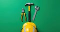Vibrant Green Backdrop for Essential Construction Tools and Yellow Safety Hard Hat Royalty Free Stock Photo