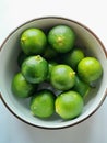 Vibrant Green Calamansi Limes in a Bowl Royalty Free Stock Photo