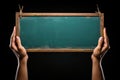 Vibrant green chalkboard with a hand holding a piece of chalk, waiting to be written on or decorated