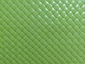 Vibrant Green Plastic Woven Texture Background with Diagonal Herringbone Pattern Royalty Free Stock Photo