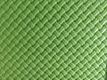 Vibrant Green Plastic Woven Texture with Diagonal Herringbone Pattern Royalty Free Stock Photo