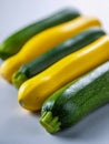 Fresh green and yellow summer squash arranged in an alternating pattern on a light surface showcasing vibrant colors and smooth Royalty Free Stock Photo