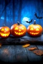 Vibrant Halloween Night A Glowing Array of Jack-O -Lanterns on an Old Wooden Stool in the Dark Royalty Free Stock Photo