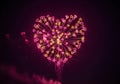 Vibrant heart shaped fireworks exploding against a dark night sky Royalty Free Stock Photo