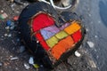 a vibrant heart-shaped patch fixed on a punctured bicycle tyre