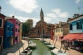 Vibrant houses along a boat lined canal in Burano, Venice, Italy - nov, 2021 Royalty Free Stock Photo