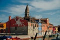 Vibrant houses along a boat lined canal in Burano, Venice, Italy - nov, 2021 Royalty Free Stock Photo