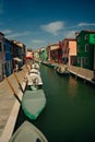 Vibrant houses along a boat lined canal in Burano, Venice, Italy - nov, 2021 Royalty Free Stock Photo