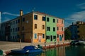 Vibrant houses along a boat lined canal in Burano, Venice, Italy - nov, 2021 Royalty Free Stock Photo