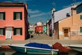 Vibrant houses along a boat lined canal in Burano, Venice, Italy - nov, 2021 Royalty Free Stock Photo