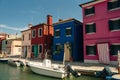 Vibrant houses along a boat lined canal in Burano, Venice, Italy - nov, 2021 Royalty Free Stock Photo